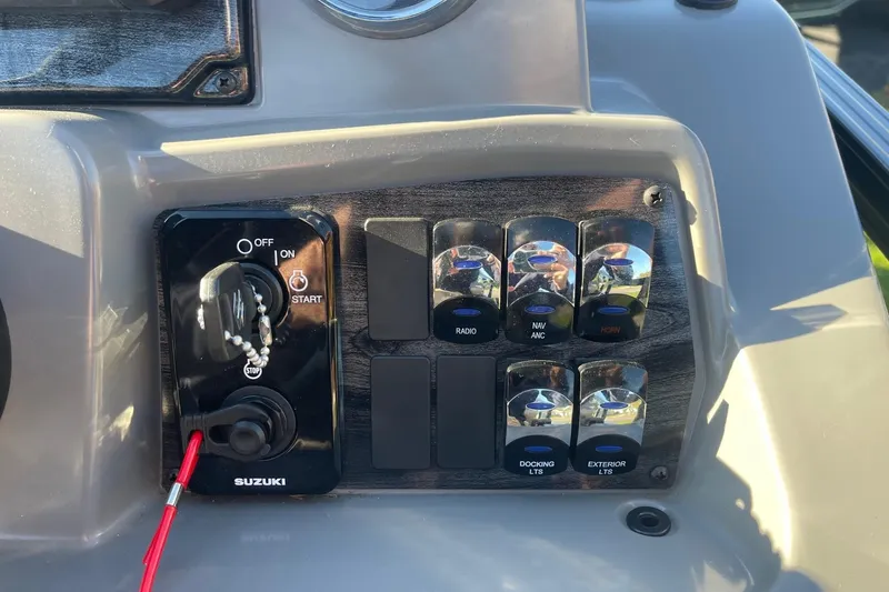 Slide: The Image of Throttle control of 2025 Avalon Venture 2585 VRB boat, featuring steering wheel and switches. - 25