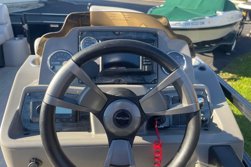 Slide: The Image of 2025 Avalon Venture 2585 VRB boat interior with open gate and seating area. - 27