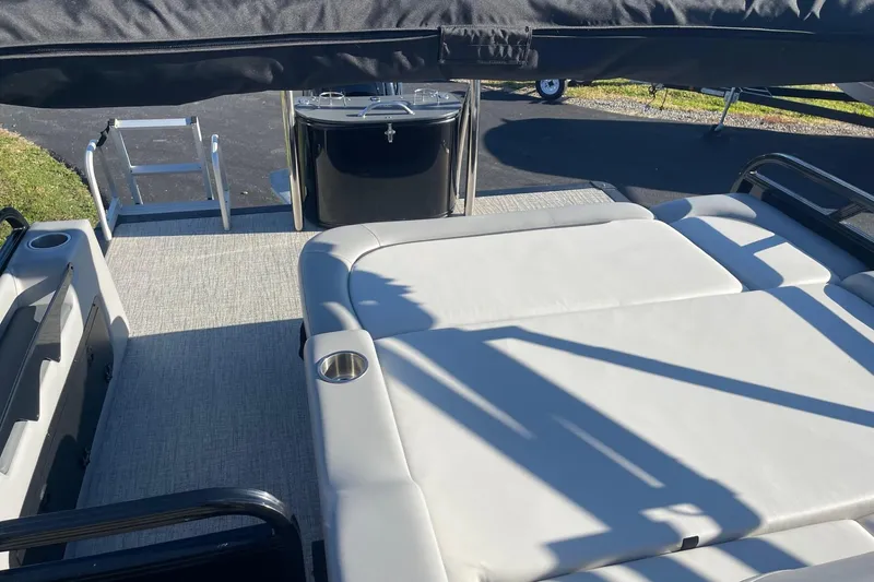 Slide: The Image of 2025 Avalon Venture 2585 VRB boat interior with gray seating and storage compartment. - 33