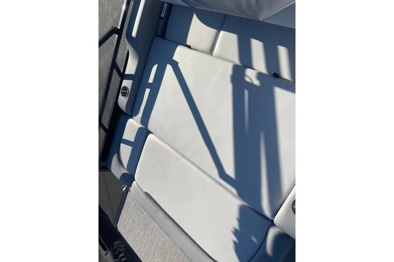 Slide: The Image of 2025 Avalon Venture 2585 VRB boat interior with luxurious seating and cup holders. - 35