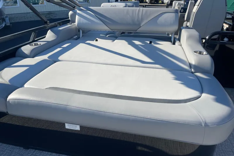 Slide: The Image of 2025 Avalon Venture 2585 VRB boat storage compartment with cup holders and sleek design. - 36