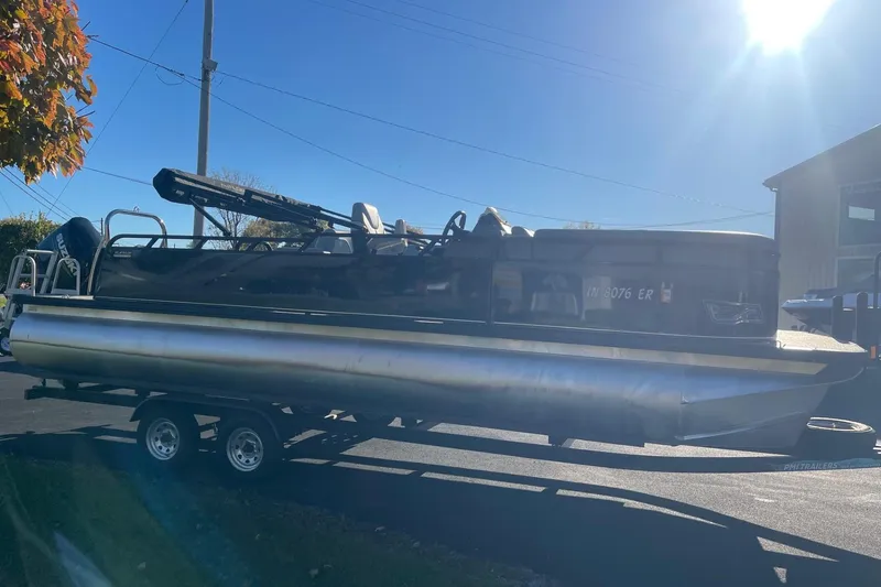 Slide: The Image of 2025 Avalon Venture 2585 VRB pontoon boat on trailer, outdoor dealership setting. - 4