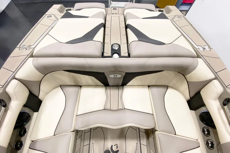 Slide: The Image of 2025 Centurion Fe22 boat interior with beige and black cushioned seating. - 10