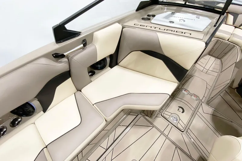 Slide: The Image of 2025 Centurion Fe22 boat interior with beige and black seating, modern design, and sleek flooring. - 12