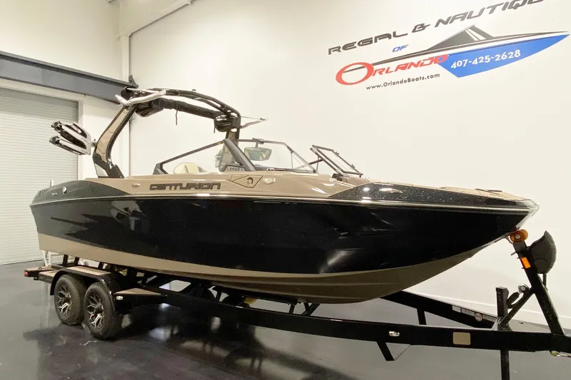 Slide: The Image of 2025 Centurion Fe22 boat on trailer in showroom, Orlando Boats signage visible. - 4