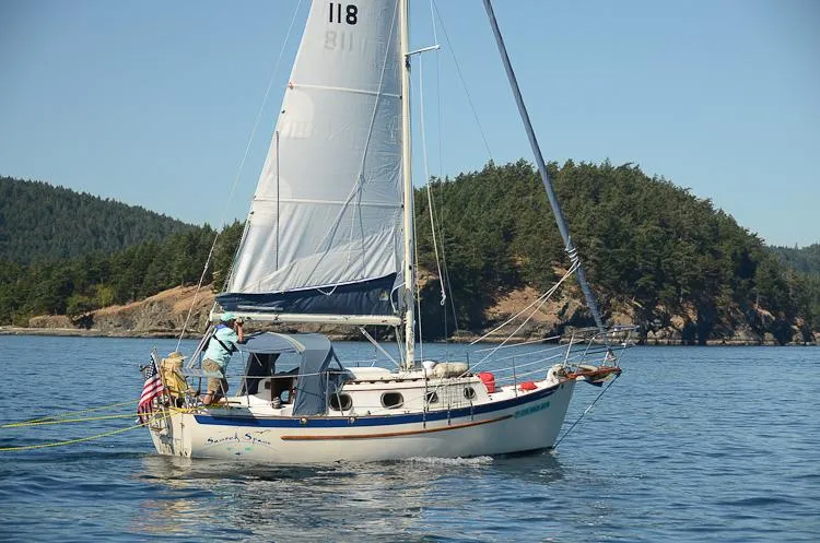 Slide: The Image of 1988 Pacific Seacraft Dana 24 sailboat on calm waters. - 4
