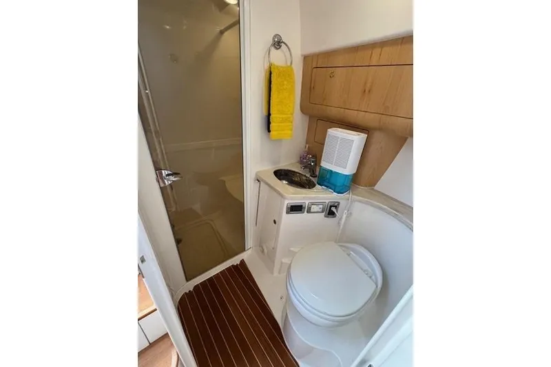 Slide: The Image of 2019 Intrepid 430 Sport Yacht bathroom with shower, sink, and toilet. - 15