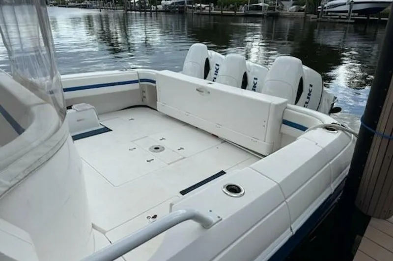 Slide: The Image of 2019 Intrepid 430 Sport Yacht with Suzuki outboard engines docked by the water. - 16