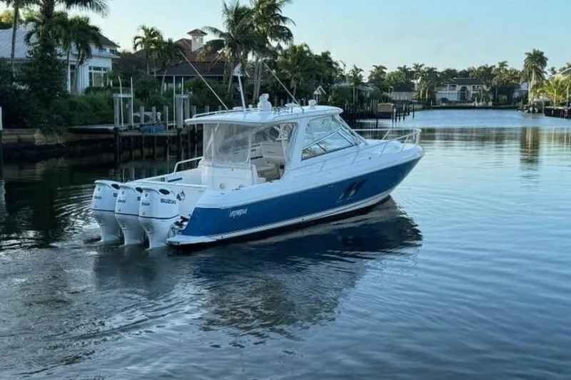 Slide: The Image of 2019 Intrepid 430 Sport Yacht cruising on a calm, scenic waterway. - 17