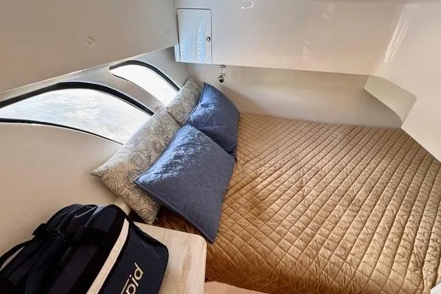 Slide: The Image of Cozy cabin interior of 2019 Intrepid 430 Sport Yacht with plush bedding and stylish decor. - 5