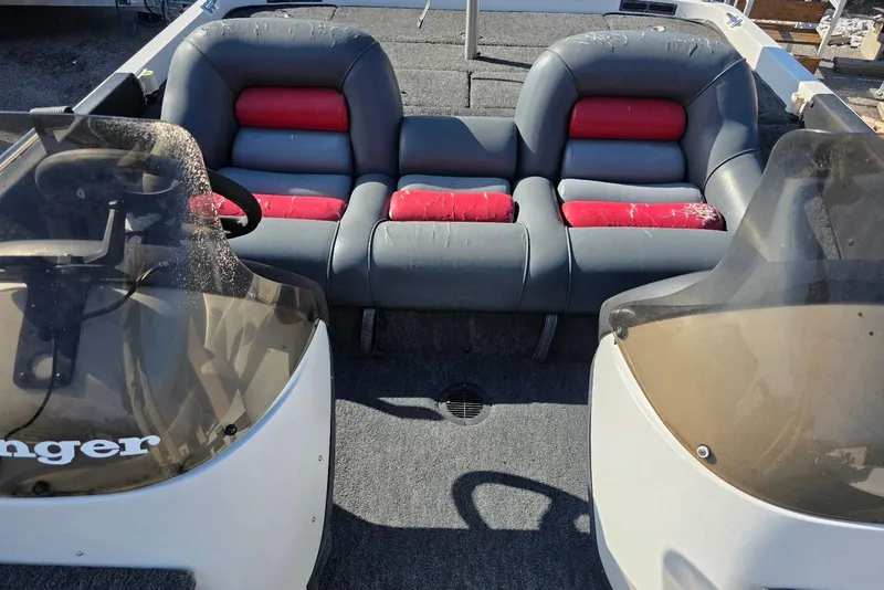 Slide: The Image of 1997 Ranger 462VS boat interior with dual consoles and red-accented seating. - 12