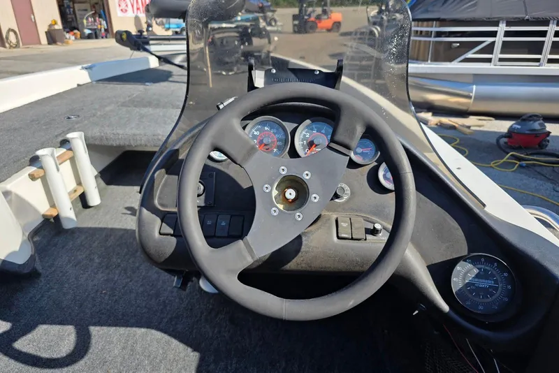 Slide: The Image of 1997 Ranger 462VS boat dashboard with steering wheel and gauges. - 13