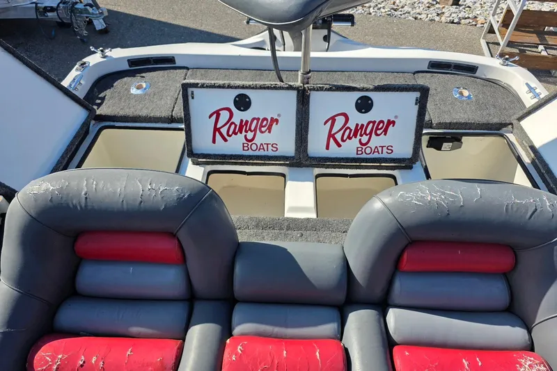 Slide: The Image of 1997 Ranger 462VS boat interior with storage compartments and worn seats. - 15