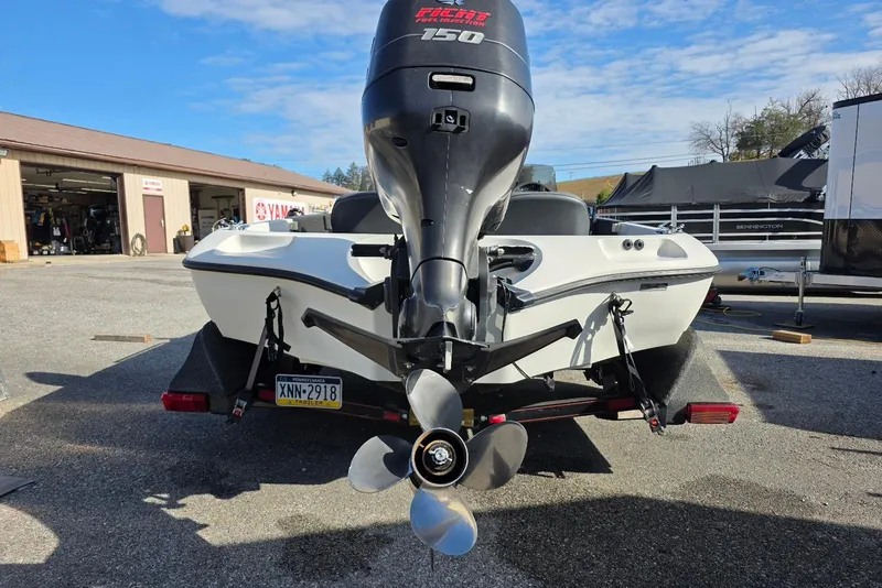 Slide: The Image of 1997 Ranger 462VS boat with a 150 HP motor, parked outdoors. - 5