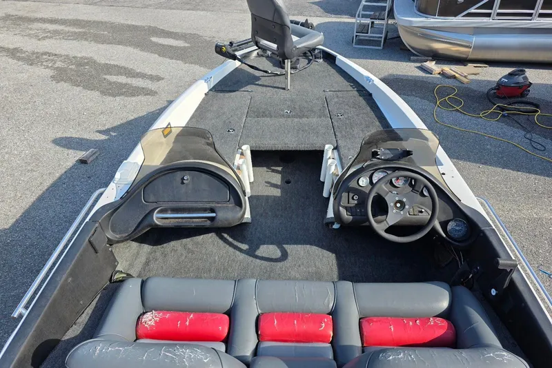 Slide: The Image of 1997 Ranger 462VS boat interior with steering wheel, seats, and carpeted deck. - 7