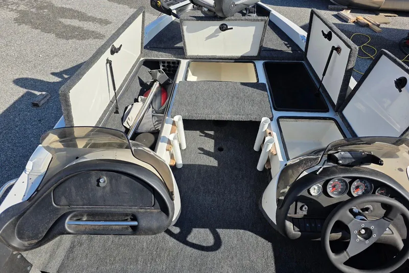Slide: The Image of 1997 Ranger 462VS boat interior with open storage compartments and steering console. - 9