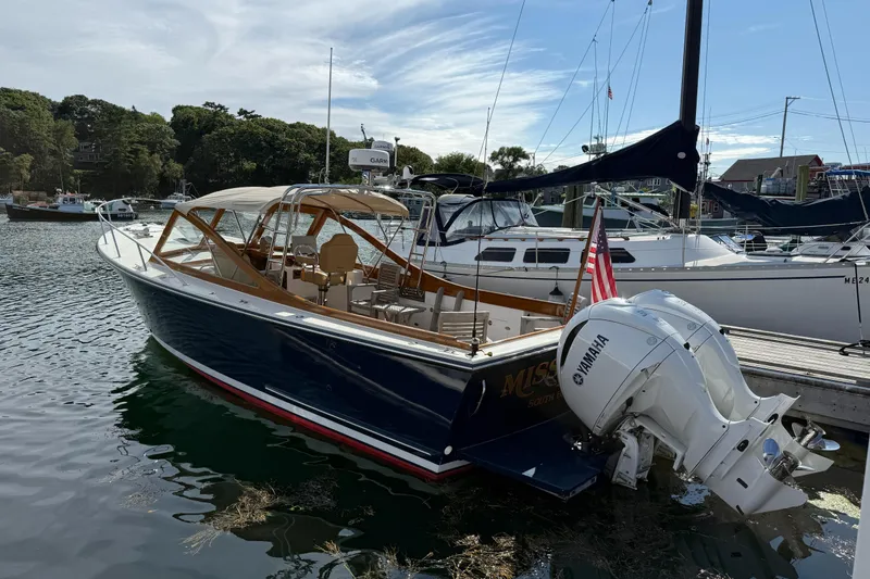 The Image of 2013 Black Horse 29 boat docked, featuring Yamaha outboard motor and American flag. - 1