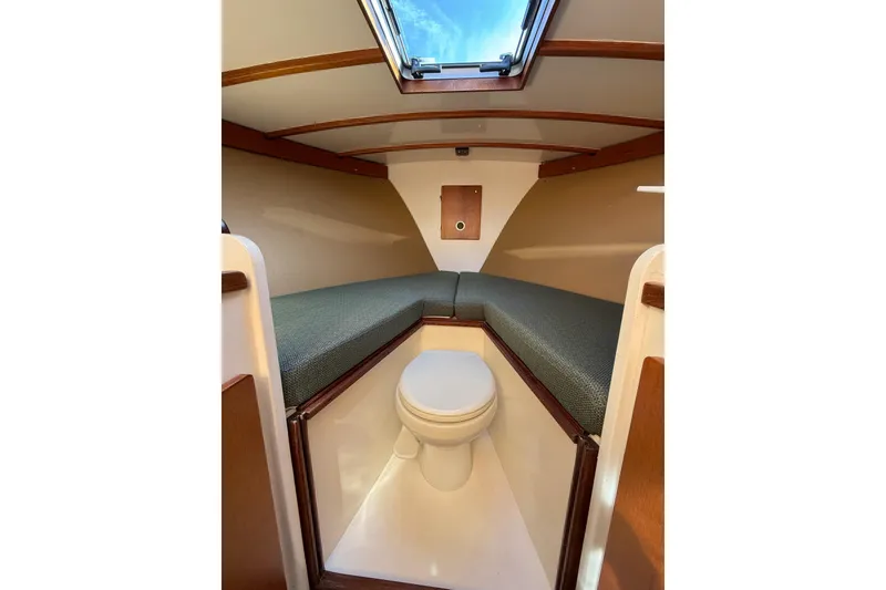Slide: The Image of Interior of 2013 Black Horse 29 boat with compact toilet and cushioned seating. - 10