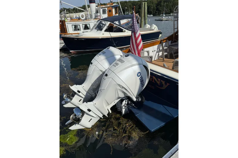 Slide: The Image of Twin Yamaha outboard motors on a 2013 Black Horse 29 boat docked in a marina. - 13