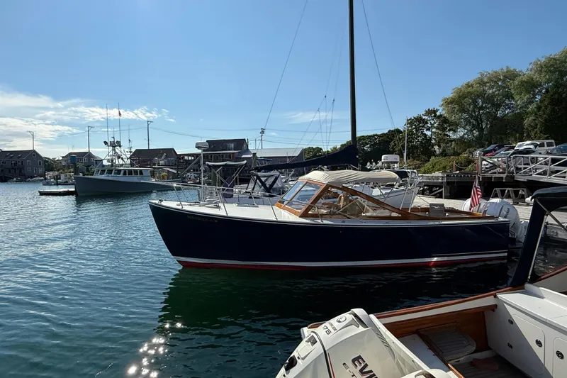 Slide: The Image of 2013 Black Horse 29 boat docked in a scenic marina under a clear blue sky. - 2