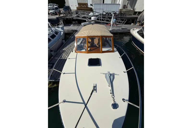 Slide: The Image of 2013 Black Horse 29 boat docked, featuring a beige canopy and sleek design. - 3