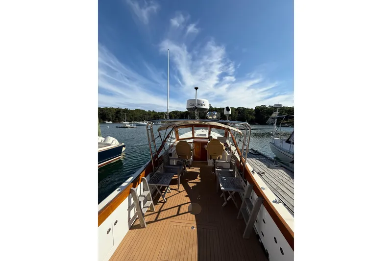 Slide: The Image of 2013 Black Horse 29 boat docked, featuring spacious deck and clear blue sky. - 4