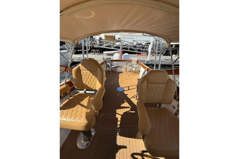 Slide: The Image of Interior of 2013 Black Horse 29 boat with tan leather seats and wooden deck. - 6