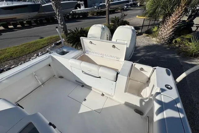 Slide: The Image of 2015 Tidewater 280 CC Adventure boat with open storage compartments and dual engines. - 13