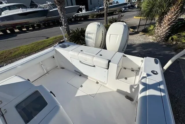 Slide: The Image of 2015 Tidewater 280 CC Adventure boat with dual outboard motors, docked outdoors. - 14
