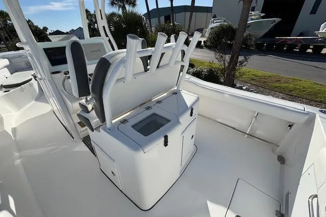Slide: The Image of 2015 Tidewater 280 CC Adventure boat interior with rod holders and seating. - 15