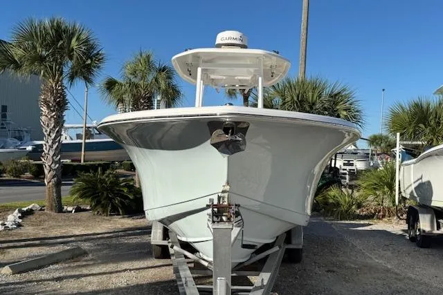 Slide: The Image of 2015 Tidewater 280 CC Adventure boat on trailer, surrounded by palm trees. - 3