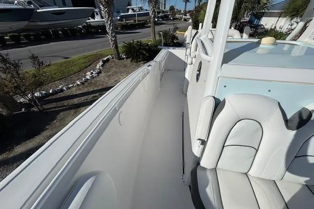 Slide: The Image of 2015 Tidewater 280 CC Adventure boat interior with white seating and sleek design. - 9