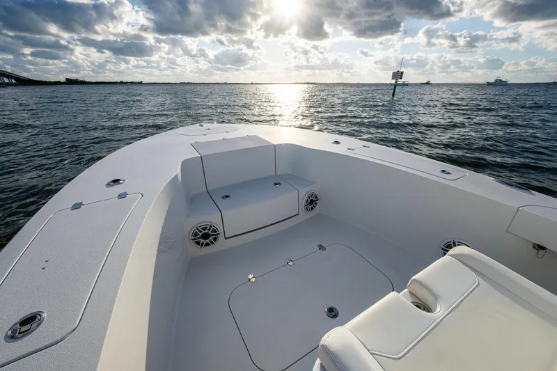 Slide: The Image of 2022 Conch 25 boat interior with seating, ocean view, and cloudy sky. - 12