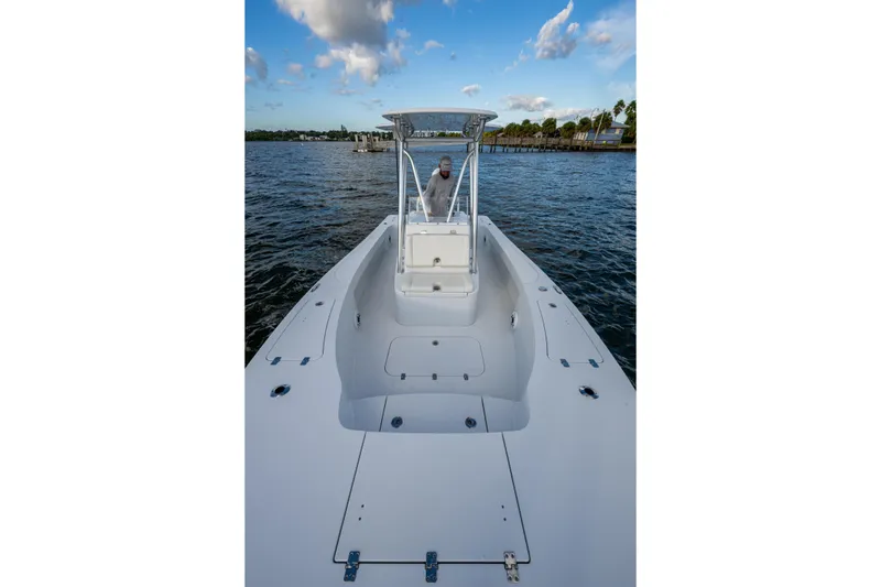 Slide: The Image of 2022 Conch 25 boat on water, clear sky, person at helm. - 14