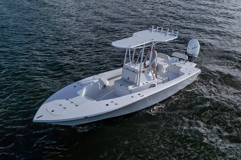 Slide: The Image of 2022 Conch 25 boat cruising on open water, featuring sleek design and modern outboard motor. - 15