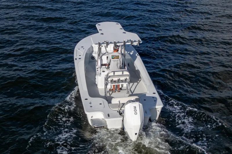 Slide: The Image of 2022 Conch 25 boat cruising on open water, rear view. - 16