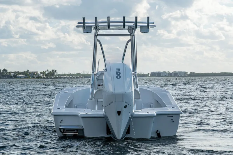 Slide: The Image of 2022 Conch 25 boat on water, rear view with clear sky background. - 17