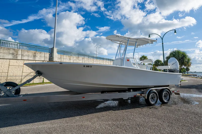 Slide: The Image of 2022 Conch 25 boat on trailer under blue sky, ready for launch. - 2