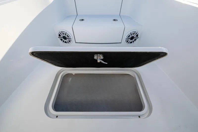 Slide: The Image of Open storage compartment on 2022 Conch 25 boat with speakers visible. - 6