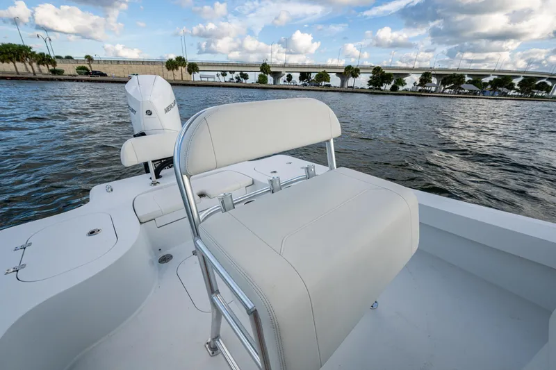 Slide: The Image of 2022 Conch 25 boat with white seating, on a scenic waterway under a cloudy sky. - 8