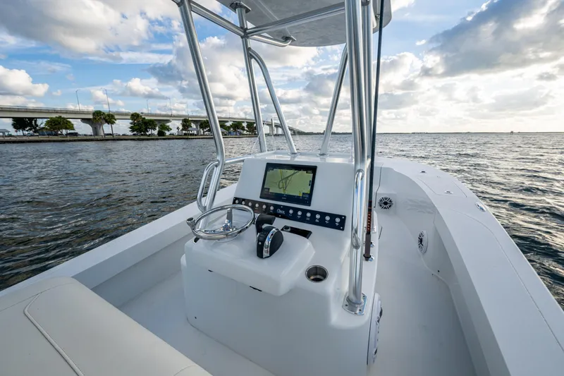 Slide: The Image of 2022 Conch 25 boat with modern console on open water, bridge in background. - 9