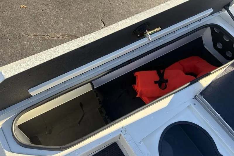 Slide: The Image of Open storage compartment in 2024 Ranger RB200 boat with orange life jacket. - 12