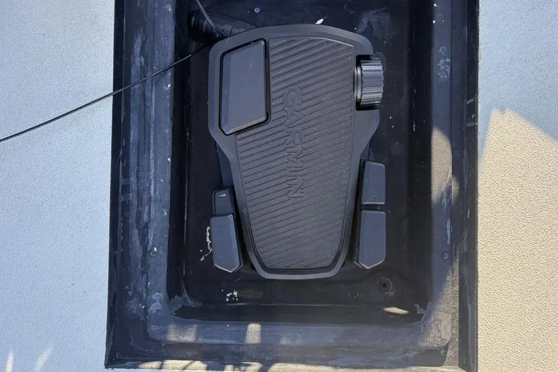 Slide: The Image of Garmin foot pedal in a 2024 Ranger RB200 boat, mounted on a textured surface. - 16