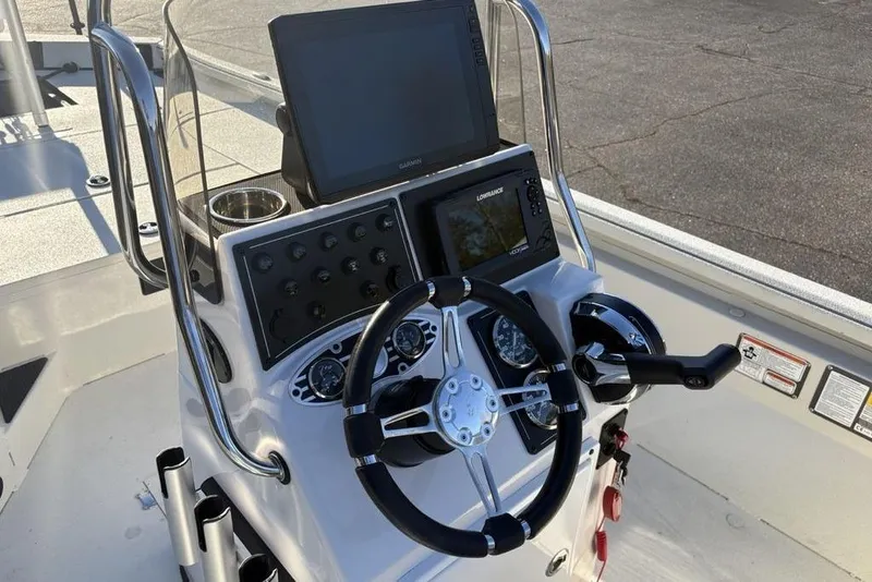 Slide: The Image of 2024 Ranger RB200 boat console with steering wheel, navigation screens, and control panel. - 20
