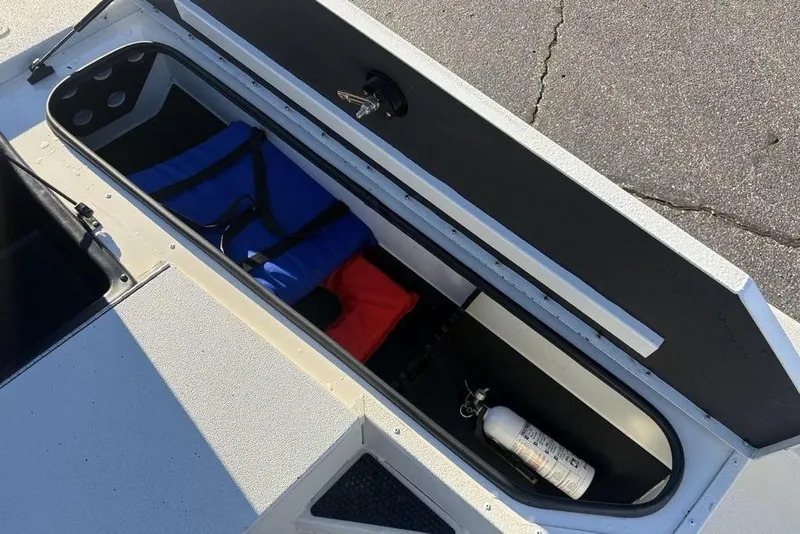 Slide: The Image of 2024 Ranger RB200 boat storage compartment with safety equipment and gear. - 22