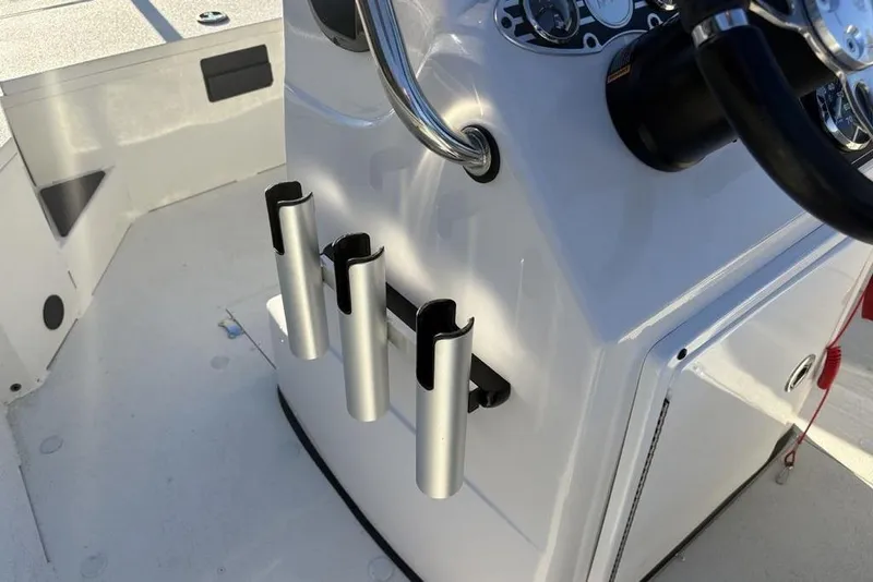 Slide: The Image of 2024 Ranger RB200 boat console with rod holders and steering wheel. - 23