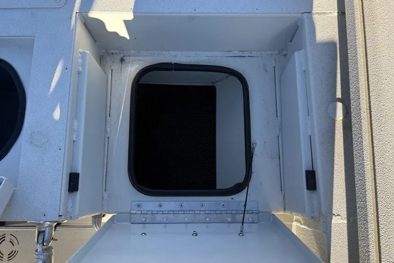 Slide: The Image of 2024 Ranger RB200 boat hatch, open and viewed from above, showing interior details. - 27