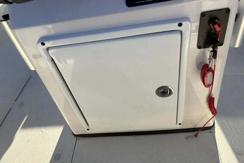 Slide: The Image of 2024 Ranger RB200 boat console with storage compartment and safety lanyard. - 28