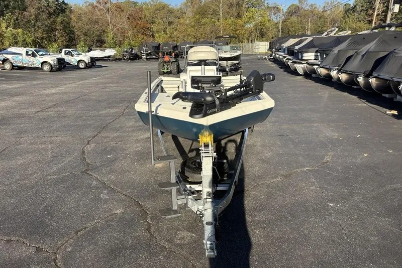 Slide: The Image of 2024 Ranger RB200 boat on trailer in parking lot, surrounded by other boats and vehicles. - 3