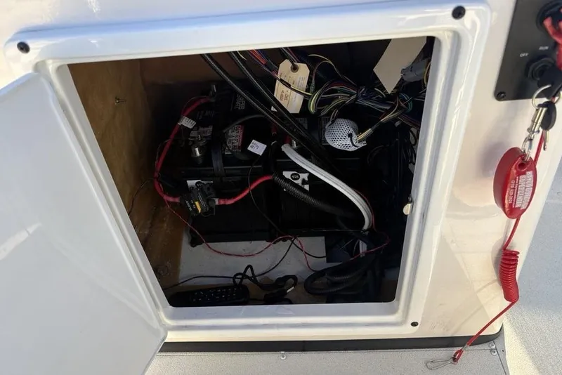 Slide: The Image of 2024 Ranger RB200 boat compartment with battery and wiring visible. - 30